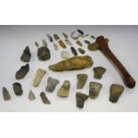A collection of archaeological stone artifacts, including a tranchet axe head, Mesolithic cores