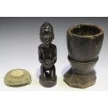 An African carved hardwood figure of a kneeling female, height 27cm, an ethnic carved wooden mortar,