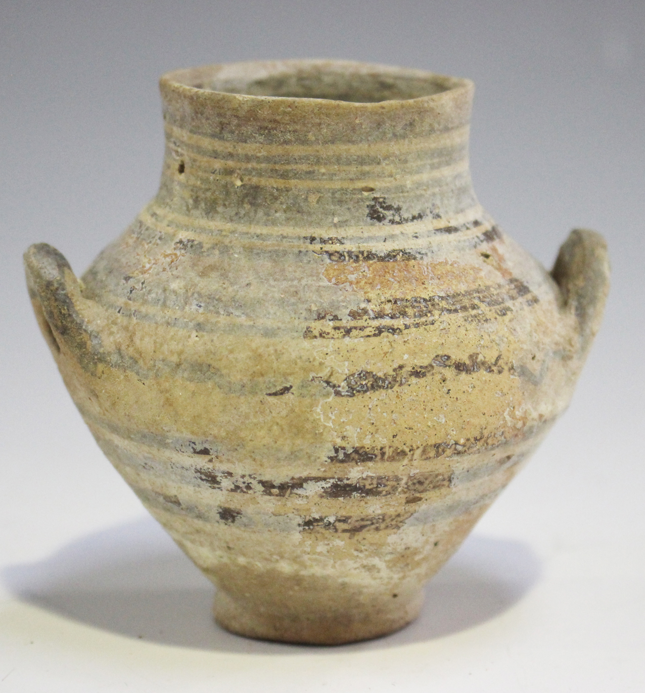 An Ancient Cypriot amphoriskos, circa 1100-1050BC, the ovoid body with two loop handles and