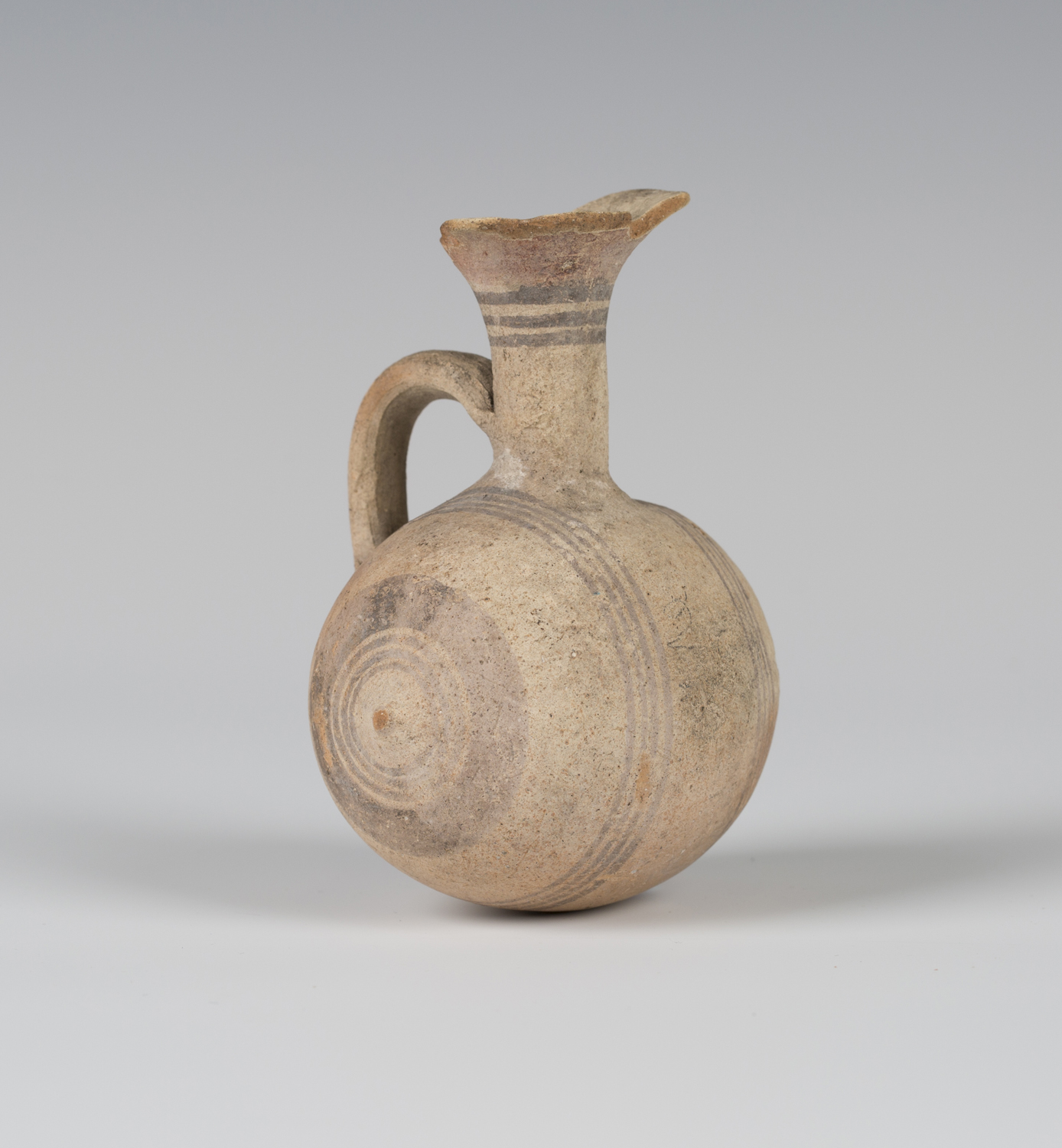 An Ancient Cypriot small terracotta barrel-shaped flask, circa 750-600BC, the flared neck and