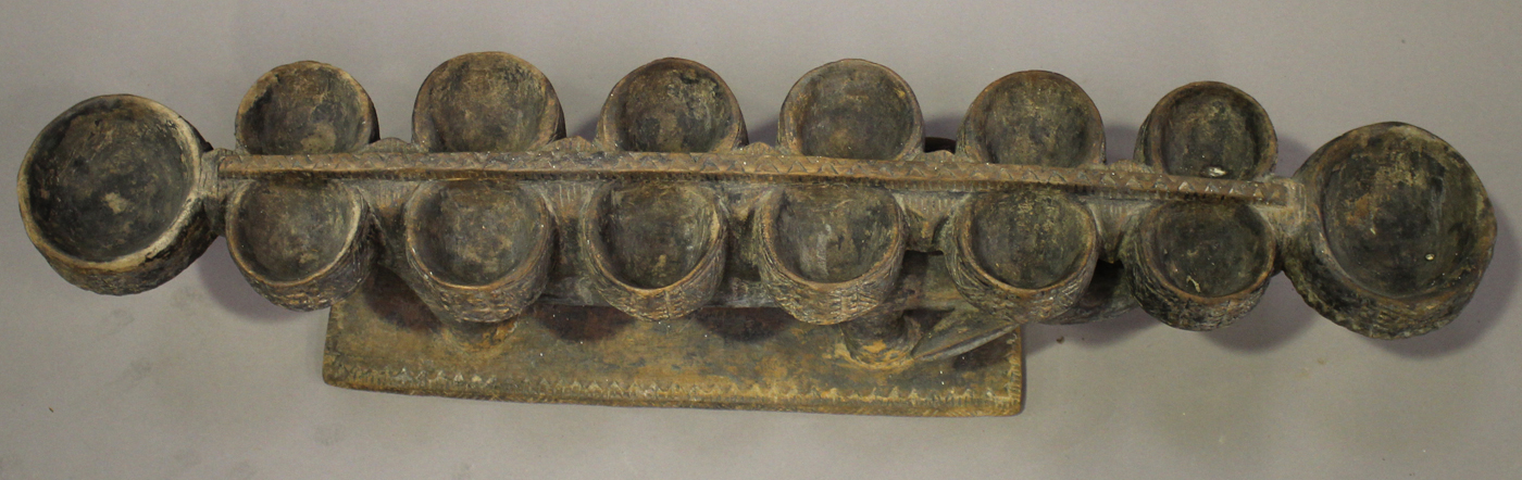 An African carved hardwood mancala board, modelled in the form of a stylized crocodile, raised on - Image 3 of 3