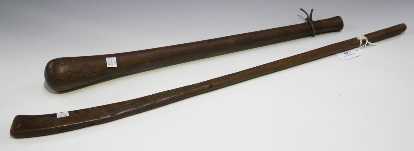 An African 'gun stock' club with overall incised decoration, length 73cm, together with another