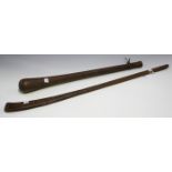 An African 'gun stock' club with overall incised decoration, length 73cm, together with another