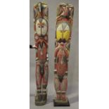 A pair of large African carved and polychrome painted full-length figures, modelled as a male and