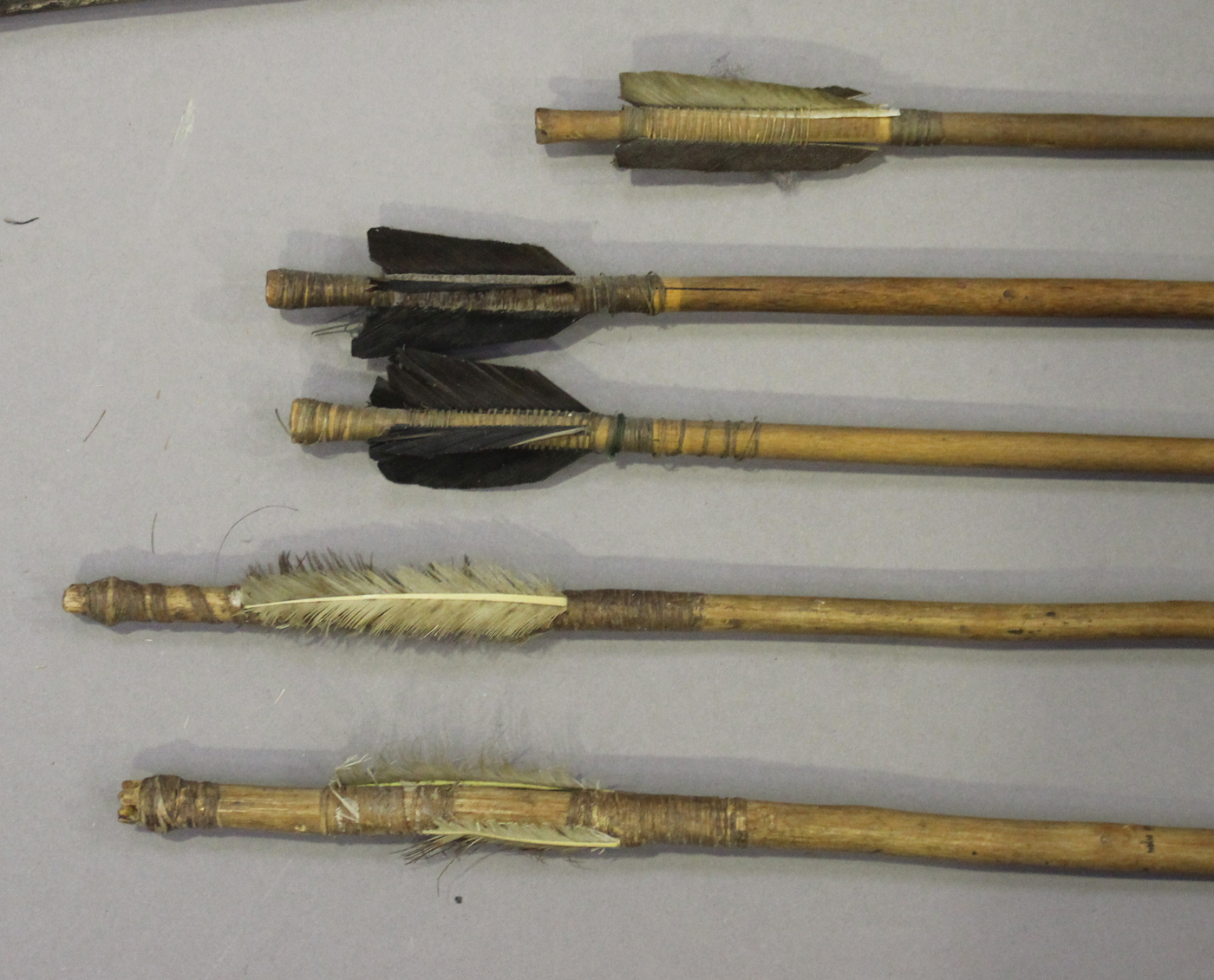 An African wooden bow, a group of five African arrows and an elephant's tail whip.Buyer’s Premium - Image 3 of 3