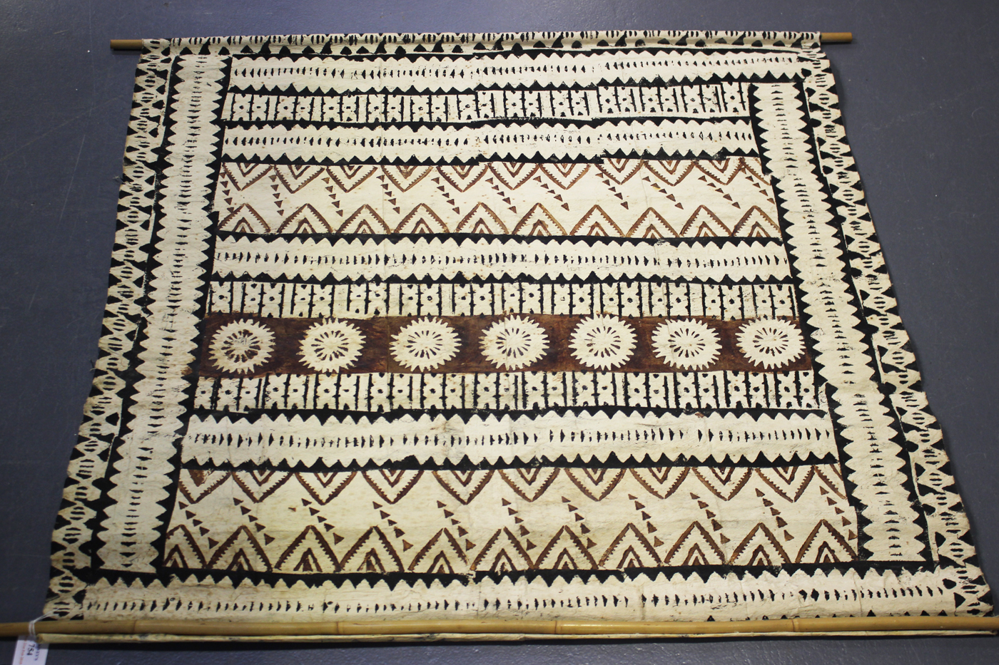 A South Seas tapa cloth with overall geometric bands in black and brown pigments, 91cm x 95cm.