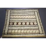 A South Seas tapa cloth with overall geometric bands in black and brown pigments, 91cm x 95cm.