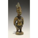 A Yoruba Ere Ibeji carved wooden female figure with applied bead bands, height 28.5cm. Provenance: