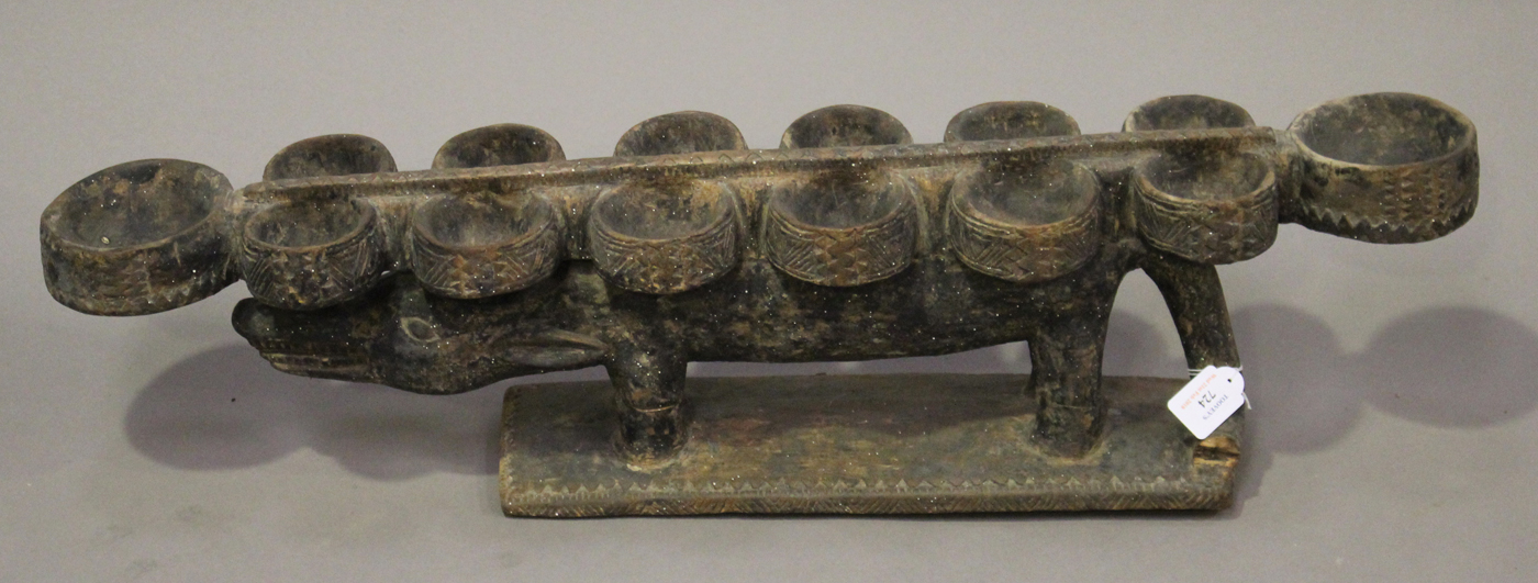 An African carved hardwood mancala board, modelled in the form of a stylized crocodile, raised on - Image 2 of 3