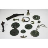 A small collection of bronze and other metal archaeological artifacts, including brooches, a
