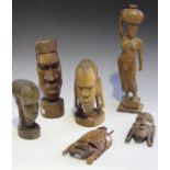 A group of mid-20th century African items, including carved wood busts, masks and figures.Buyer’s