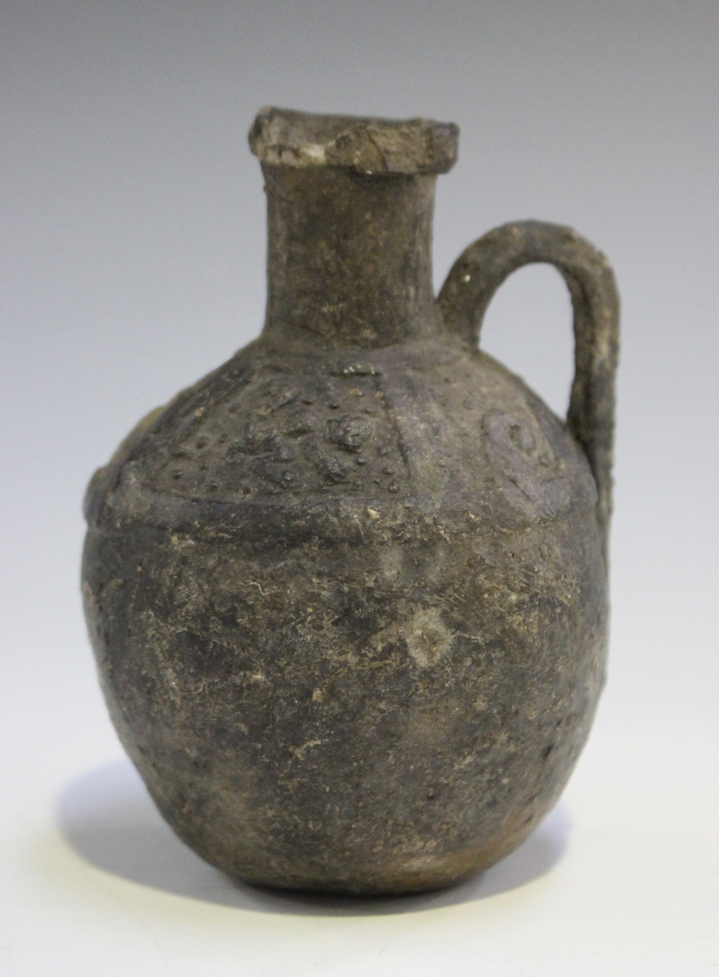 An Ancient Etruscan Bucchero ware oil jug, approx 6th century BC, the body with a loop handle, the