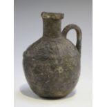 An Ancient Etruscan Bucchero ware oil jug, approx 6th century BC, the body with a loop handle, the