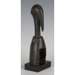 A Senufo carved hardwood heddle pulley, Ivory Coast, modelled as the head of a stylized hornbill