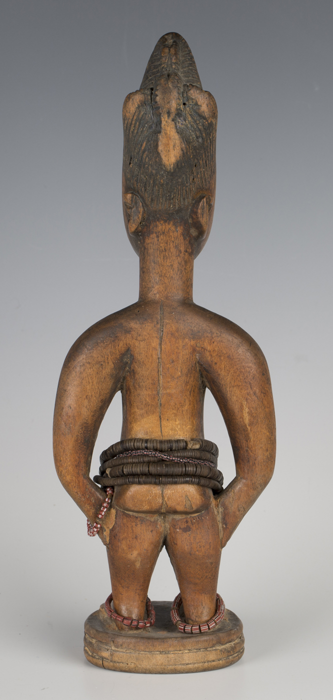 A Yoruba Ere Ibeji carved wooden female figure with applied bead bands, height 28.5cm. Provenance: - Image 2 of 2