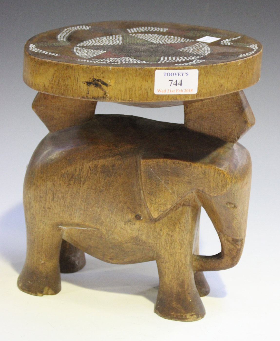 An East African carved wooden Kamba stool, Kenya, the circular seat with inset beaded decoration