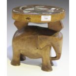An East African carved wooden Kamba stool, Kenya, the circular seat with inset beaded decoration