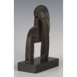 A Senufo carved heddle pulley, Ivory Coast, the finial modelled as the head of a hornbill with