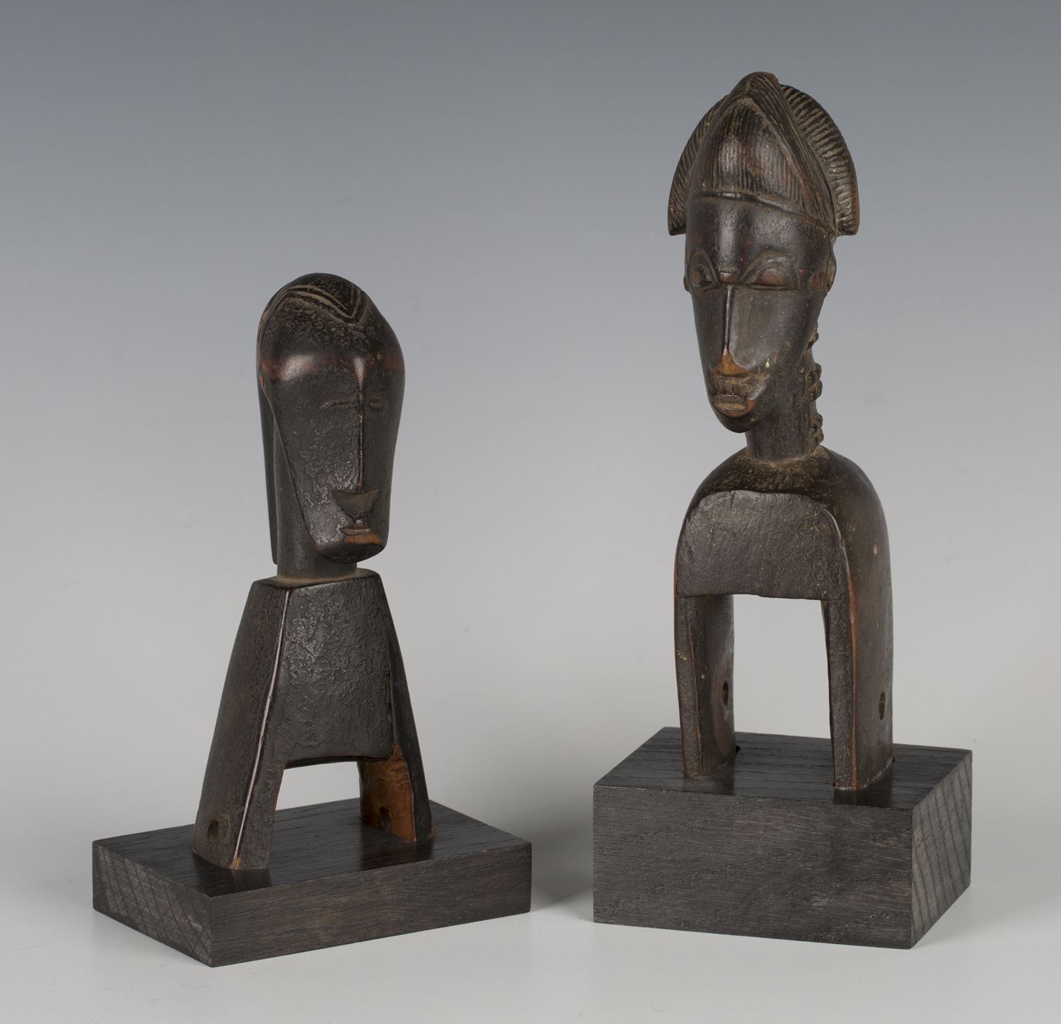 A Baule carved hardwood heddle pulley, Ivory Coast, with incised coiffure and keloid