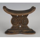 A Shona carved wooden headrest, Zimbabwe, the curved rectangular upper platform above a twin support