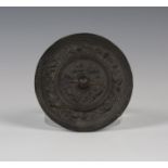 A Chinese archaic bronze circular mirror, probably Tang dynasty (618-907), one side cast with lion