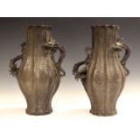 A pair of Chinese brown patinated bronze dragon-handled vases, late Qing dynasty, each lobed