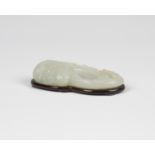 A Chinese pale celadon jade Feng form brushwasher, Qing dynasty, finely carved with the bird