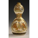 A Japanese Satsuma earthenware double gourd vase, Meiji period, the upper bulb painted and gilt with