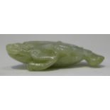 A Chinese carved jade pendant of a three-legged toad, probably late Qing dynasty, carved in relief