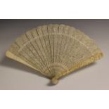 A Chinese Canton export ivory brisé fan, mid-19th century, the guards carved in relief with figures,