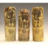 Three Chinese carved soapstone seals, 20th century, each of cylindrical shape, relief carved with