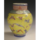 A Chinese famille rose enamelled yellow ground porcelain vase, mark of Jiaqing but late Qing