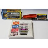 A collection of die-cast vehicles, including a Matchbox King Size K-10 pipe truck, within a window