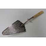 A George III silver and ivory handled fish slice with pierced scroll blade and tapering handle