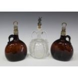 A pair of Victorian silver mounted brown glass flask decanters with silver stoppers, of typical