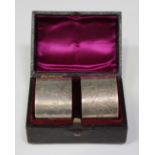 A pair of Victorian silver napkin rings, each front engraved with a bird amidst fern fronds,