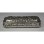 A Victorian silver trinket box of rectangular form with domed hinged lid, embossed and engraved with