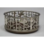 A late Victorian silver wine coaster of circular form, the sides pierced and engraved with birds and