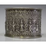A late 19th century Indian silver cylindrical box with hinged lid, the sides embossed with a