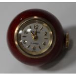 A Baume silver gilt and red enamelled spherical pendant watch, the jewelled movement detailed 'Swiss