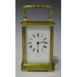 A late 19th century French brass cased carriage clock with eight day movement repeating and striking