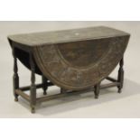 An 18th century oak drop-flap dining table, later carved with a central reserve depicting the