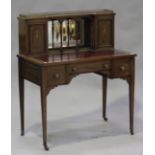 An Edwardian mahogany lady's writing table with inlaid decoration, the mirrored shelf back fitted