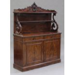 A mid-19th century French figured mahogany side cabinet, the shelf back with carved scroll