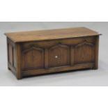 A 20th century oak coffer, the removable top above panelled sides, on stile supports, height 52cm,