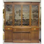 A late Victorian mahogany breakfront secrétaire bookcase cabinet, the moulded pediment above four