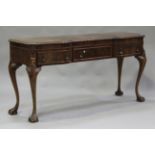 An early 20th century walnut inverted breakfront serving table, the moulded top above three drawers,