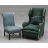 An early 20th century wing back armchair, upholstered in green fabric, height 106cm, width 70cm,