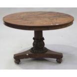 A William IV figured mahogany circular tip-top breakfast table, raised on a turned stem with a