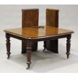 A mid-Victorian mahogany extending dining table with two extra leaves, raised on turned and reeded